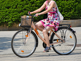 Young woman rides a bicycle on the city street © majorosl66