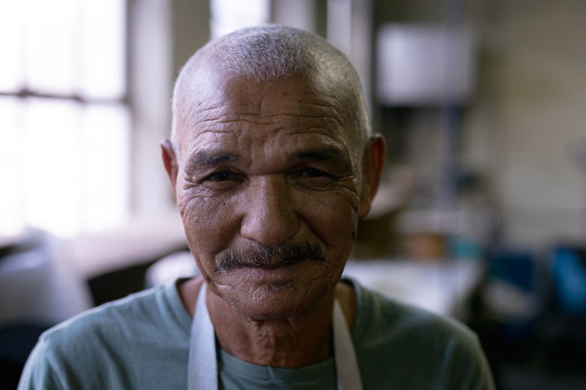 Portrait of man standing in a hat factory