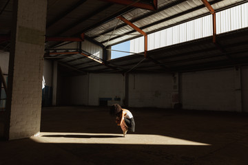 Female dancer in an empty warehouse