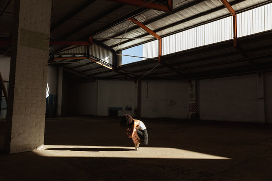 Female dancer in an empty warehouse
