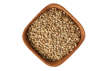 Organic whole hemp seeds in wooden bowl isolated on white background