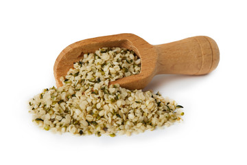 Organic shelled hemp seeds in wooden scoop isolated on white background