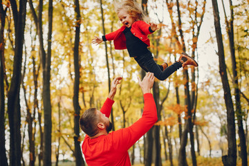 Family with cute little daughter. Father in a red sweater