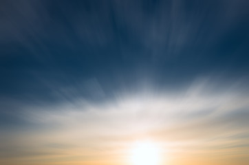Sunset and cirrus clouds on a bright blue sky.