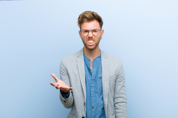 young businessman looking angry, annoyed and frustrated screaming wtf or what‚Äôs wrong with...
