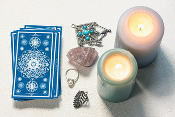 Blue tarot cards on white stone table background.