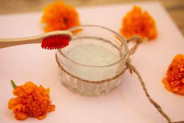 Wooden brushes, tooth powder, on a pink background. Zero waste concept, close up.