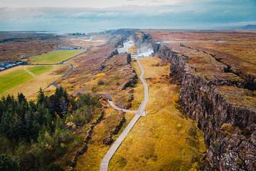 Top view Rocky canyon with waterfall in Iceland, autumn landscape
