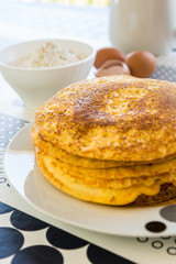 Stack of pancakes with baking ingredients