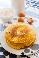 Stack of pancakes with baking ingredients