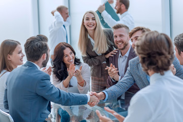 business group applauding business partners during the meeting.