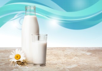 Obraz na płótnie Canvas Glass of milk and bottle on background