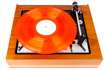 Vintage turntable with a red vinyl isolated on white
