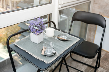 Empty coffee cups on the balcony with sunlight in the morning. Breakfast preparations. Hotel or...