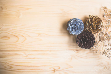 pine cone with dry grass flower on wooden background for Christmas decorative.