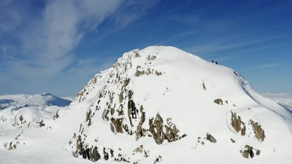 Unidentified people walking to the mountain top, sunny winter day in Northern Sweden. Breathtaking view over Scandinavian Mountains