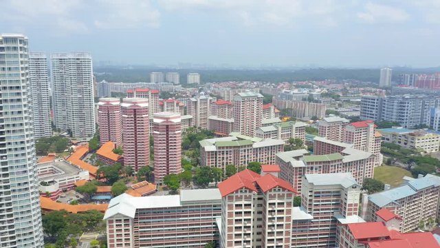 Aerial 4k footage of Public Housing Apartments of Singapore with Singapore skyline In Front Of A Nature Park In Singapore