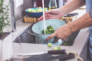 washing raw Brussels sprouts in kitchen sink