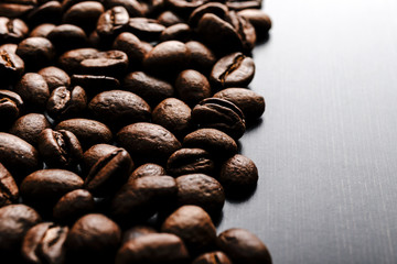 Coffee beans on wooden background.