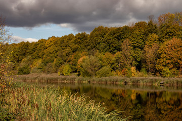 Autumn landscape, colorful forest on the lake