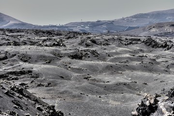 Views on black lava mountains during discovery tour Termesana route in Timanfaya national park, Lanzarote, Canary Islands, Spain