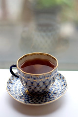 Fruit tea in a vintage porcelain cup. Selective focus.