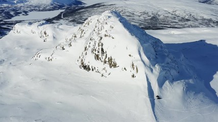 Sweden, drone flying sunny winter day close to mountain in Lappland, Northern Sweden. Breathtaking view over Scandinavian Mountains