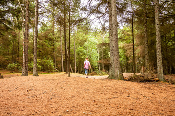 Frightened little girl lost in the dense forest wilderness