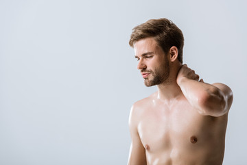 Fototapeta premium shirtless bearded man with neck pain isolated on grey