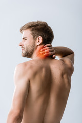 shirtless bearded man with neck pain isolated on grey