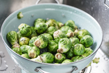 washing raw Brussels sprouts in kitchen sink