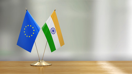 European Union and Indian flag pair on a desk over defocused background  - 291937850