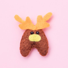 Deer felt on a pink background.