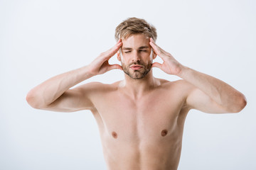 Fototapeta premium front view of shirtless man with migraine touching temples isolated on grey