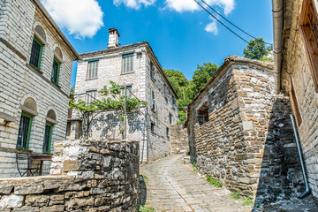 Fototapeta na wymiar Traditional alley in Mikro Papingo village in Ioannina during summer, Greece