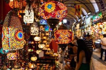 Souvenir store in big bazaar, people observing traditional lamps in the shop