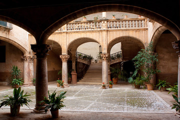 Fototapeta na wymiar Old villa in town on Palma de Mallorca with columns and old stairs 