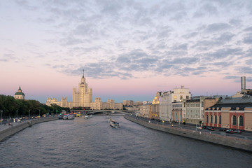 Moscow view at dusk. Clouds create special atmosphere. Kotelnicheskaya skyscraper and boat tours by...