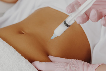 Woman's having lipolysis treatment