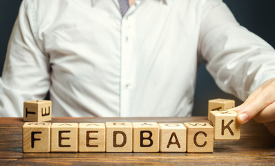 Wooden blocks with the word Feedback and critic. The concept of the rating of hotels and...