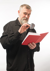 old man with a book with glasses