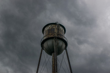 Fototapeta na wymiar water tower with clouds