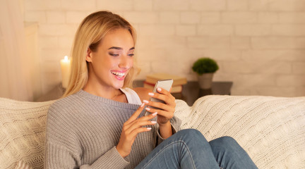Millennial Girl Using Cellphone Sitting On Sofa At Home, Panorama