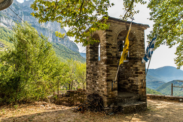 Bell tower of Taxiarchon church in the village of micro Papingon, Ioannina, Greece