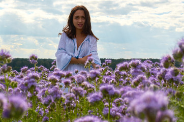 girl in white dress in a field of flowers