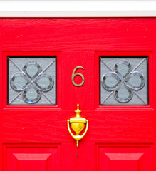 House number 6 on a bright red wooden front door