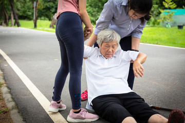 Sick asian senior mother with heat stroke,high temperature,vertigo on floor after falling...