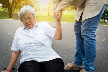 Asian elderly woman fell to the floor after tripped over something, female caregiver or daughter...