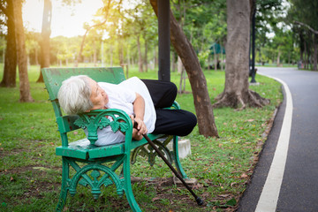 Alzheimer asian senior woman confusion with time or place,memory loss suffering age-related,female patient with dementia people sleeping on the bench in outdoor park,alzheimer’s disease of elderly
