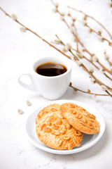 Spring breakfast. Light breakfast. Coffee with peanut cookies. Breakfast on a white background. Willow branches